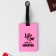 Tag on a rubber suitcase "Life is ABOUT Adventure", pink