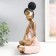 Polystone souvenir "Girl with curly tails, with a dish" pink-gold 17x12x27 cm
