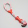 A training cable toy with a bone, up to 120 g, up to 40 cm, mix of flowers