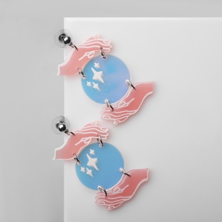Acryl Earrings "Planet" in the hands, colored in silver