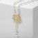 Pearl with pearls "bow" large, white color in gold, 70 cm