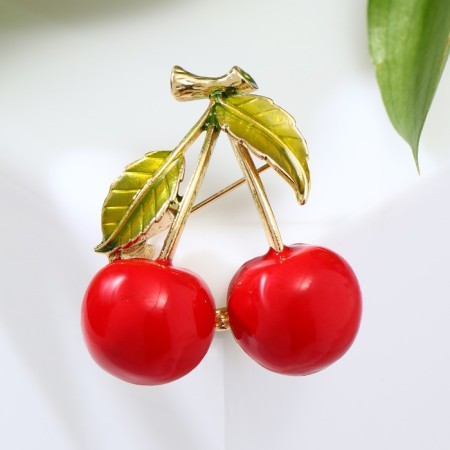 Brooch "Cherry" with two leaves on a branch, the color is red-green in gold