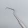 Bilateral, elongated, 16.3 cm, silver color.