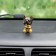 Dog on a car panel shocking his head, German shepherd
