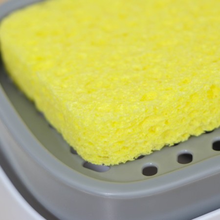 A dispenser for a detergent with a stand for the Raccoon sponge, a sponge included-2