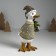 Polystone souvenir "Goose in a sweater in peas, carries the Christmas tree" Light green 9.5x12x22.5 cm