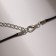 Piece on the cord "handcuffs", color black silver on a black lace, 42 cm