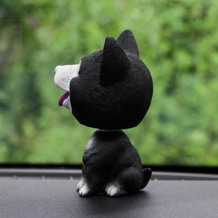 Dog on a car panel shocking his head, Husky, black-1