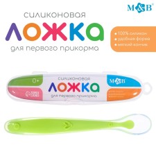 A spoon for a nursery, for the first feeding, in a container, green