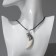 Unisex pendant "Tiger Fang", white color in black silver on a black lace, 40 cm