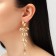 Hanging earrings with rhinestones "bun" deciduous, golden color in gold, 9.5 cm