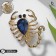 Brooch "Scorpio" drop, black and blue color in gold