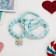 The kit of children's “chosen” 3 objects: elastic band, 2 bracelets, flower, blue matte color