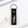 Kezzle keychain to the leatherette "First in everything!", 11 x 2.5 cm