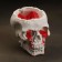 Figure candle in concrete "Crying skull", red
