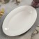 Oval porcelain dish with a thickened edge of the White Label, 30.5 × 20 × 3 cm, white color