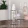 A bottle for storage, with a spray, with a division scale, 100 ml, white/transparent color