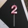 Candle for the cake, the number "2", pink.