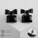 Earrings with a ostric "bow" with a rectangle, the color is black