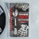 A teaspoon spoon with an “explosive character” engraving, on a gift card, 3 x 14 cm.