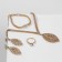 Set 4 objects: earrings, necklaces, bracelet, ring "leaf fall", white color in gold