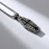 The pendant "coffin" with a skeleton, black color in black silver, l = 70 cm