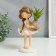 Souvenir Polystone "Baby with a scythe, with a plant in a vase" 21x9x11.3 cm