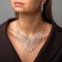 Set 2 objects: earrings, necklace of “sparks” rectangles, white color in silver, 30 cm