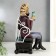 Polystone souvenir "Zebra with a glass in an armchair" 25x12x15 cm