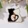 Icon "cats", black and white color in gold