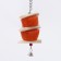 A toy with a karakatitsa carapace, lufoi and bell, 20 x 5 cm, orange