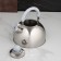 A kettle with a stainless steel whistle “marble”, 3 l, a fixed handle, chrome color