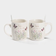 A set of ceramic mugs with spoons 