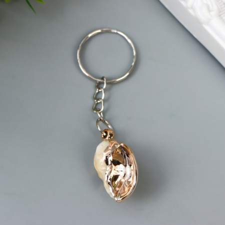 Keychain plastic "shell in a cage" with gold 3x2x1.2 cm