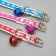 A collar of artificial leather with sparkles, 32 x 1 cm, mix of flowers