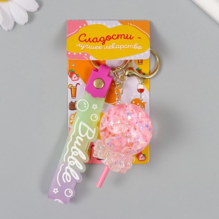 A keychain plastic with a carbine, a strap "Lollipop with a bow" Water with a glitter of 4x4x6.5 cm