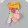 A keychain plastic with a carbine, a strap "Lollipop with a bow" Water with a glitter of 4x4x6.5 cm