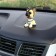 Dog on a car panel shocking his head, mini, shepherd