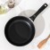 The “Tradition” pan, d = 22 cm, a plastic handle, a glass cover, a thickened bottom, anti -stick coating, black color