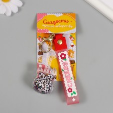 A plastic keychain with a carbine, a strap of 