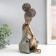 Polystone souvenir "Girl with curly tails, with a dish" under bronze 19x12x27 cm
