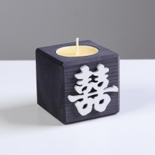 A candle in a wooden candlestick 