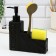 A dispenser for liquid soap with a sponge and a brush for dishes, black, 16 x 12 x 4 cm.