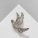 Brooch "Bird" fluttering, white color in silver