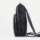 A backpack with a zipper, "saxi", outer pocket, black color