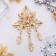 Brooch "Empress" openwork with pendants, white color in gold