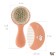 Soft comb, a comb and a scallop with a pile of sheep's wool, peach color