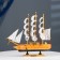 The ship souvenir medium "Ginder", board is light wood, white sails, 30x7x30 cm