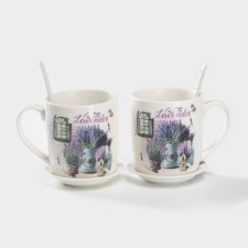 A set of ceramic mugs with spoons and stands 
