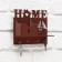 The keywood is wall -mounted with a shelf with a shelf and a “Home” pocket, 17 x 14.5 cm.